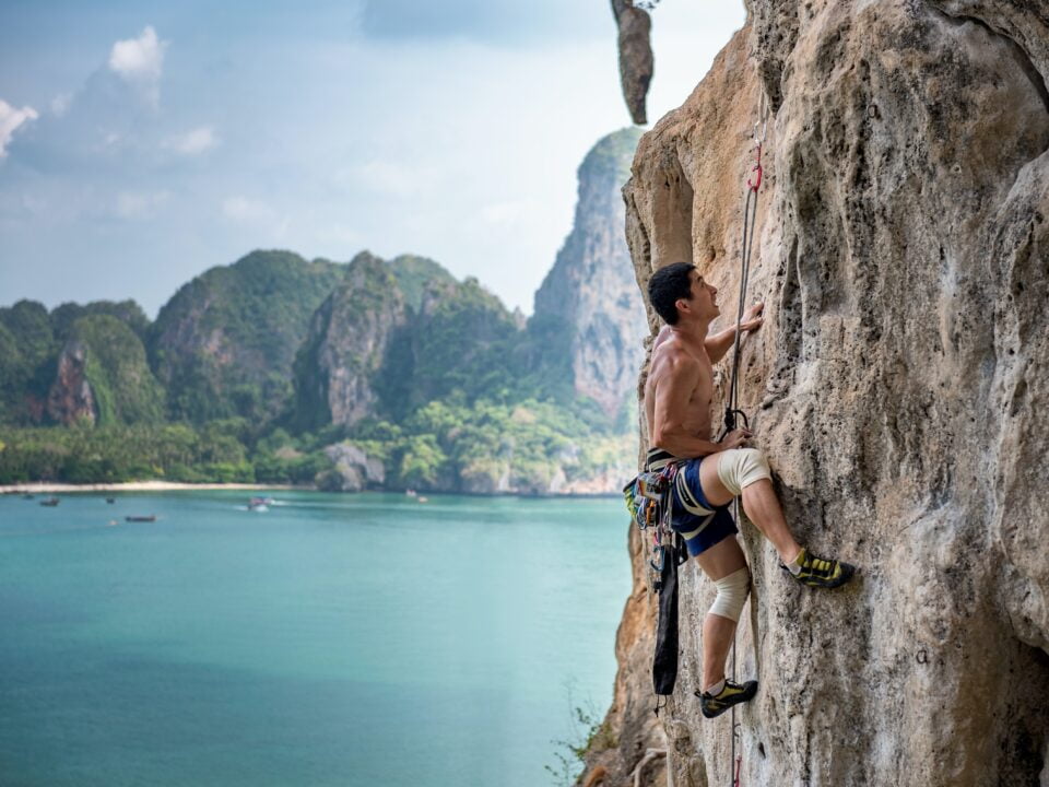 homme grimpe une falaise - différence entre escalade et alpinisme